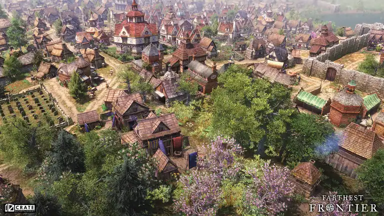 A grown town in summer: graveyard on the left, fruit trees in blossom in front, a stone wall and gate on the right.