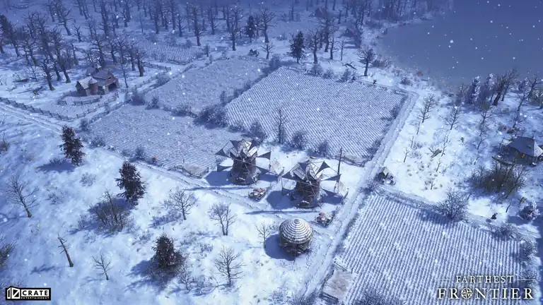 Two windmills among snow-covered crop fields in winter.