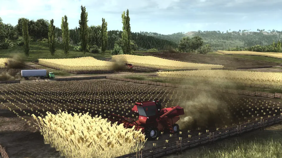 A combine harvester cutting a wheat field, with a crop truck waiting at the field edge.